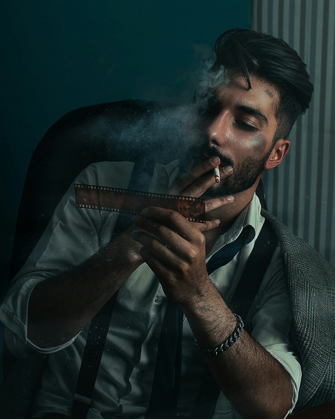 man smoking cigarette wearing gray suit