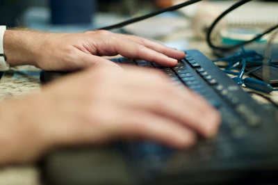 person using black computer keyboard