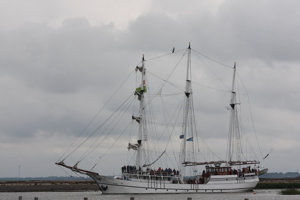 white sail boat on sea during daytime