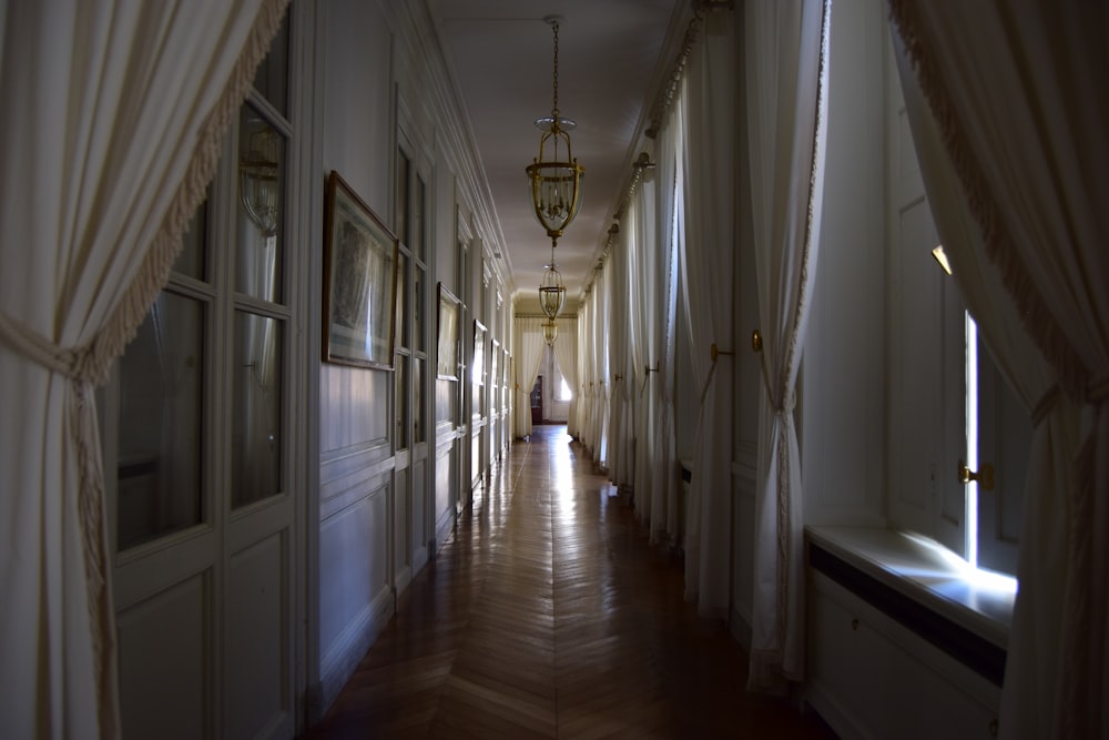 white and brown hallway with pendant lamps