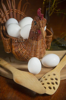 A cozy rustic kitchen corner with fresh eggs in a woven basket beside colorful handmade pottery.