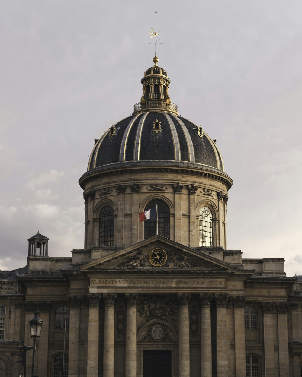 brown concrete building under white clouds during daytime