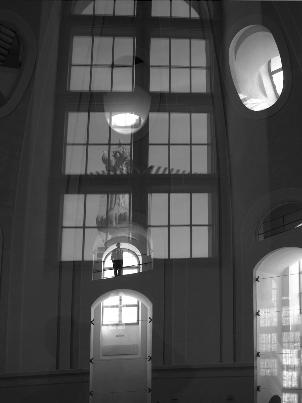 grayscale photo of round glass window