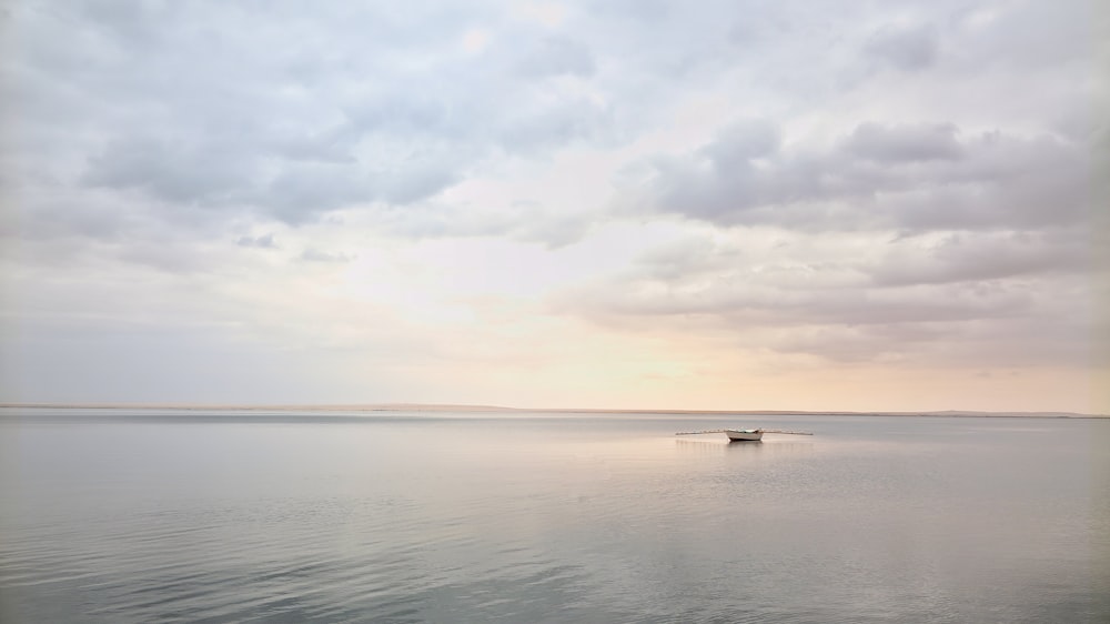 body of water under cloudy sky during daytime