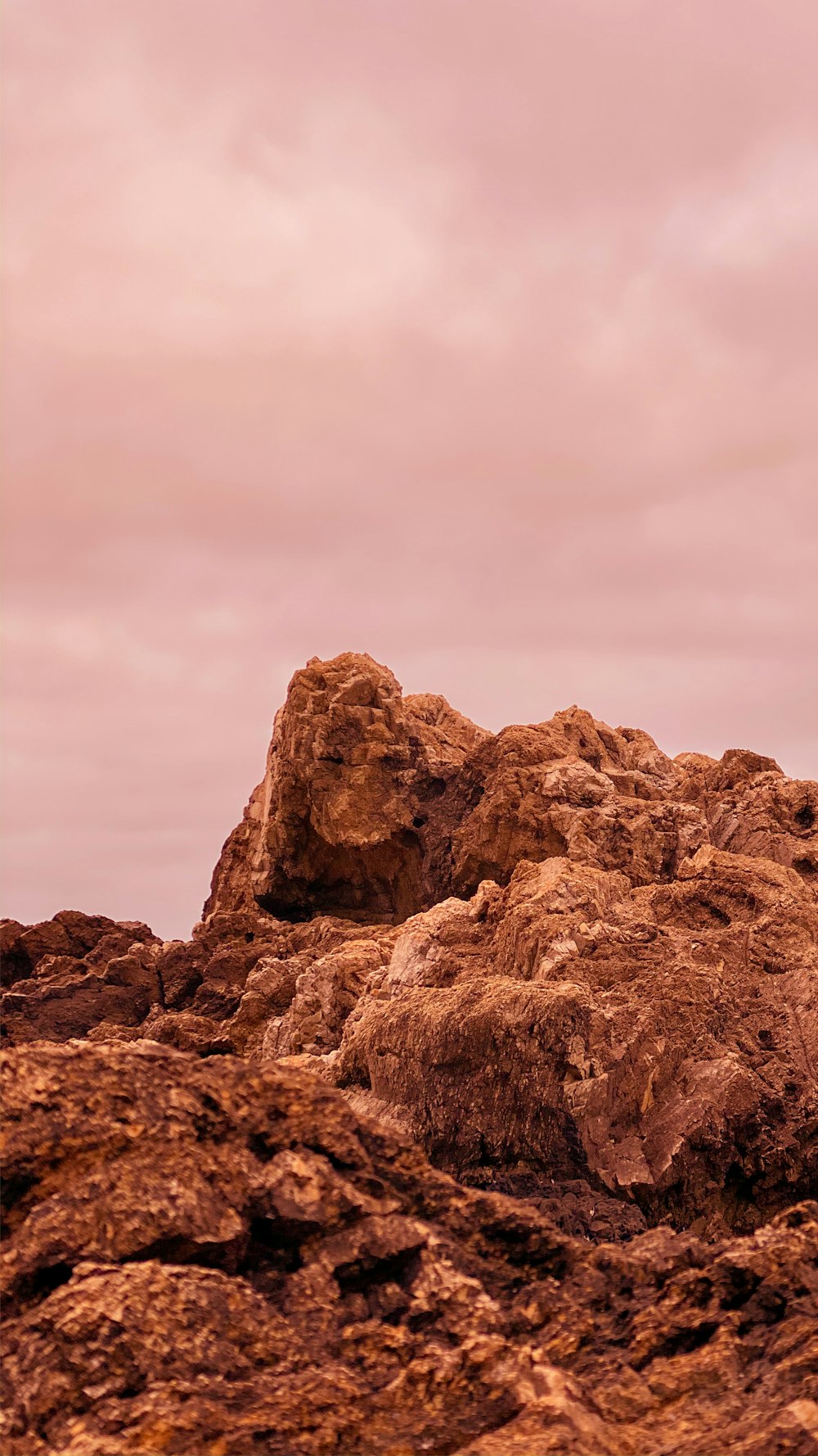 brown rock formation under white clouds during daytime