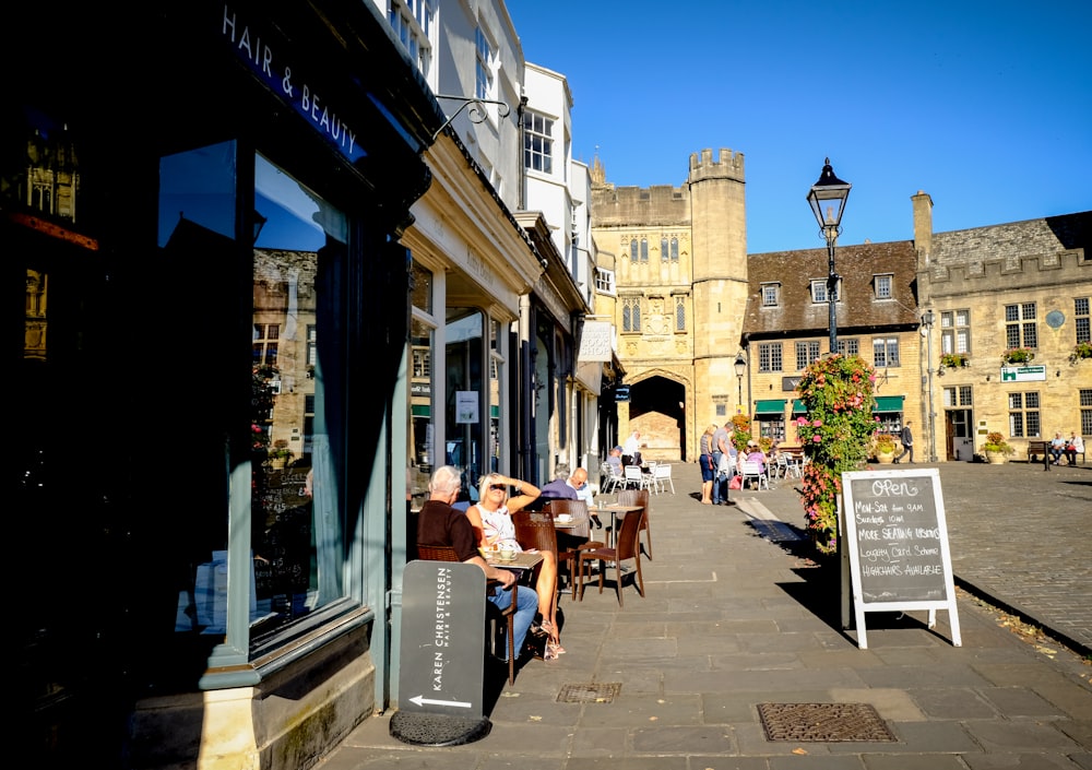 people sitting on chair near building during daytime