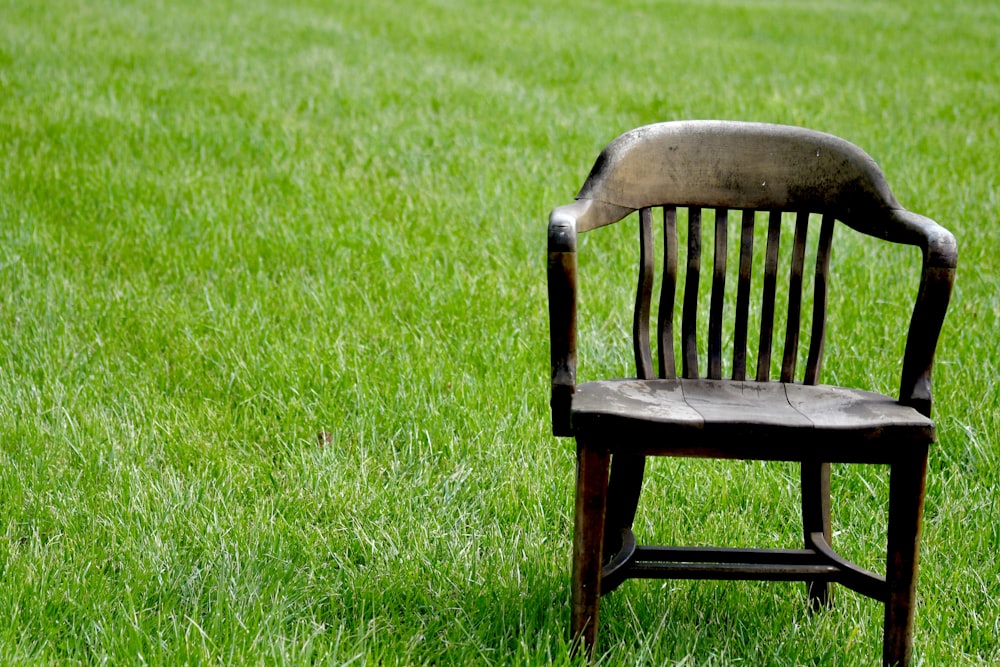 brown wooden bench on green grass field during daytime