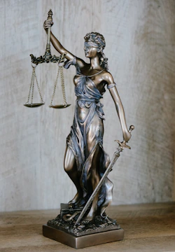Lady Justice statue representing fair legal services at Harsh Malik Law Offices.