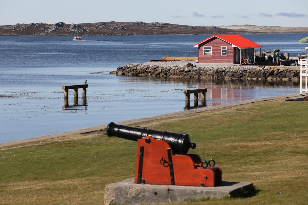 red and white house near body of water during daytime