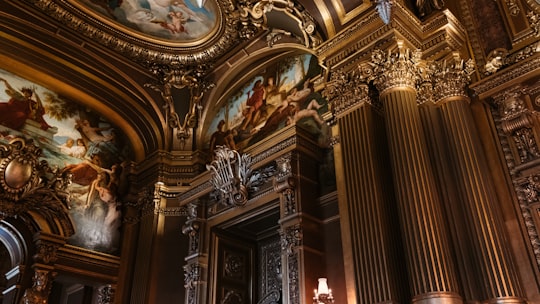 gold and white concrete building in Palais Garnier France