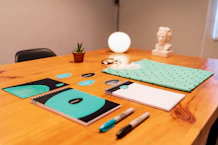 Creative mood board with color swatches and logo sketches on a desk.