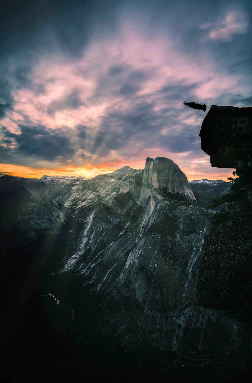 person standing on top of mountain during daytime