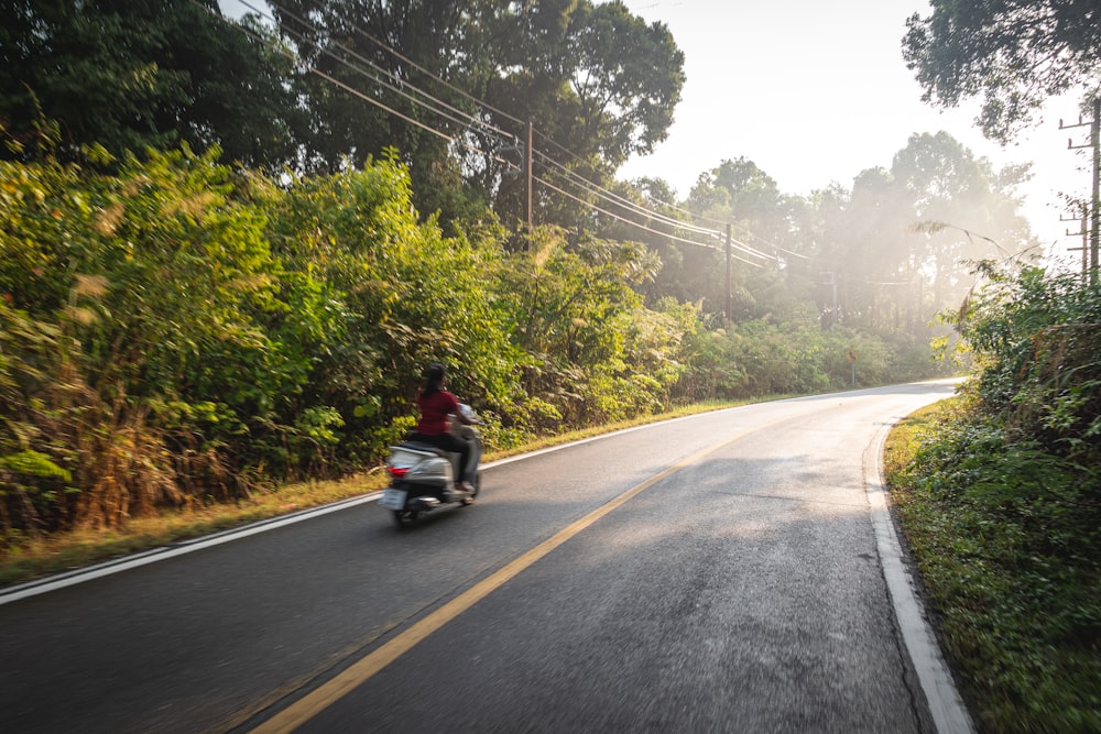 man in black jacket riding motorcycle on road during daytime