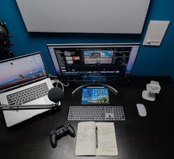 black flat screen computer monitor and black computer keyboard