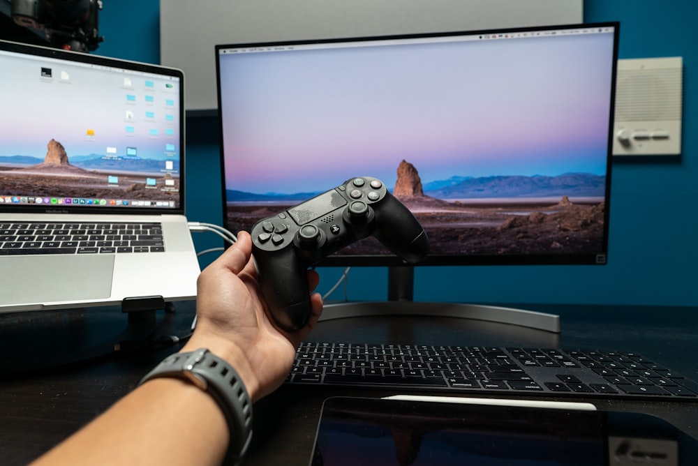 person holding black and gray game controller