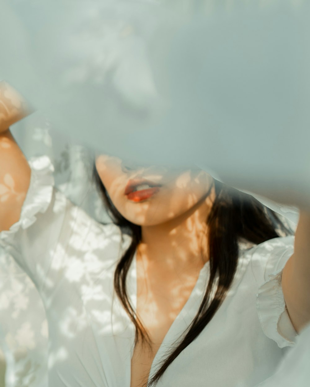 woman in white shirt with white sheer veil