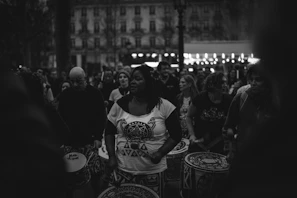 A group of drummers sharing a moment of laughter and connection during a community session.