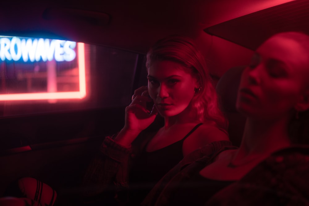 woman in black jacket sitting on car seat