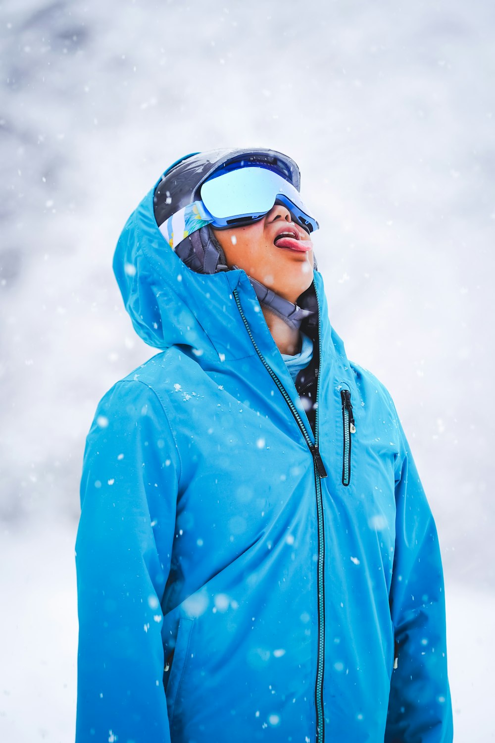 man in blue zip up hoodie wearing black sunglasses