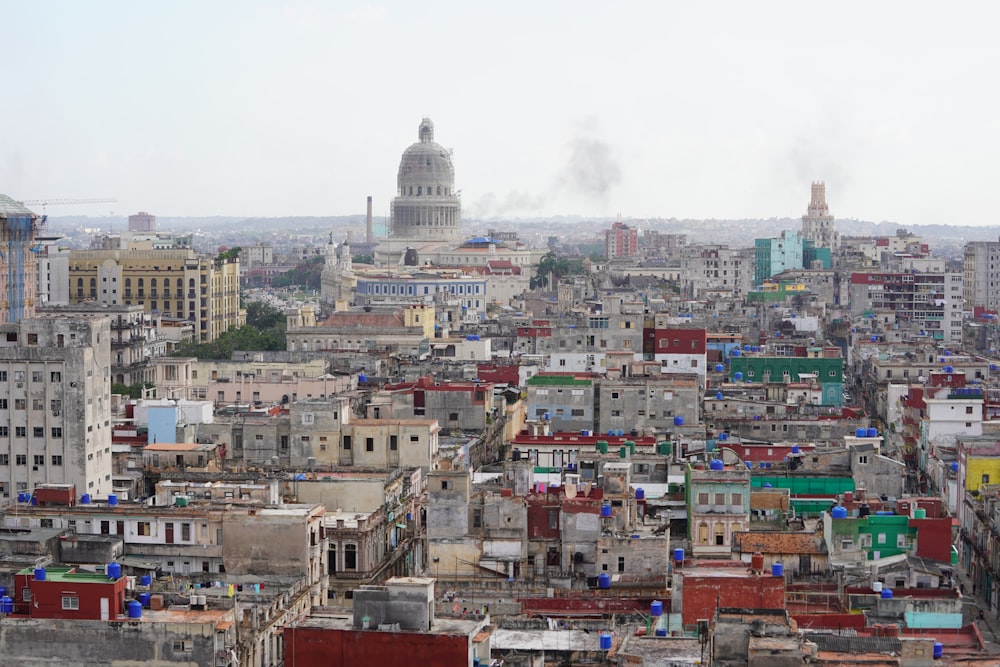 city with high rise buildings under white clouds during daytime