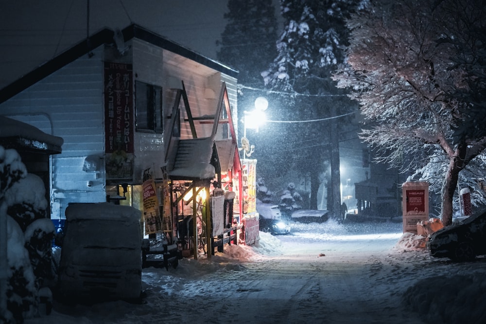 snow covered road between houses during daytime