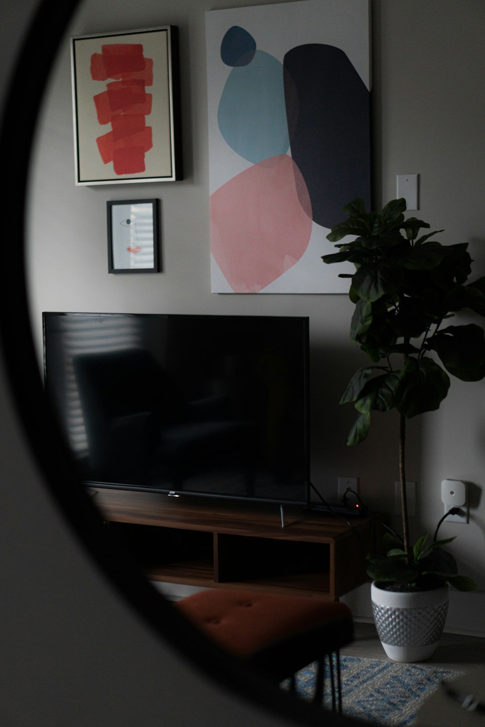 black flat screen tv on brown wooden tv rack