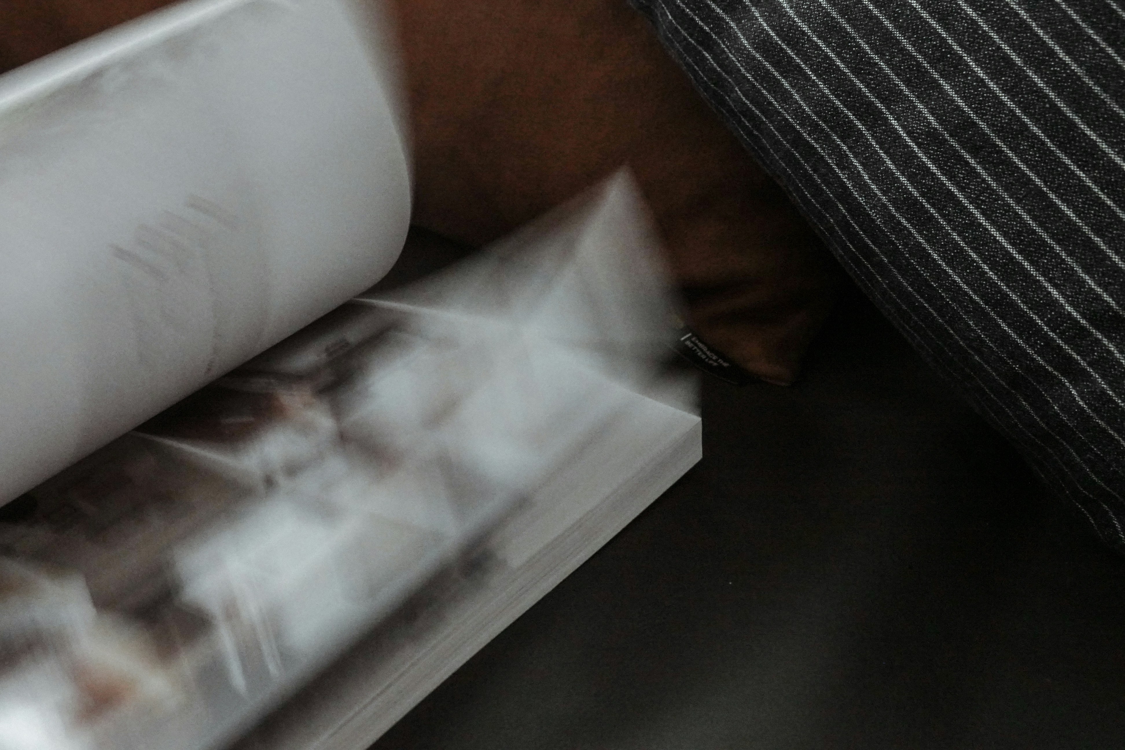 white printer paper on brown sofa