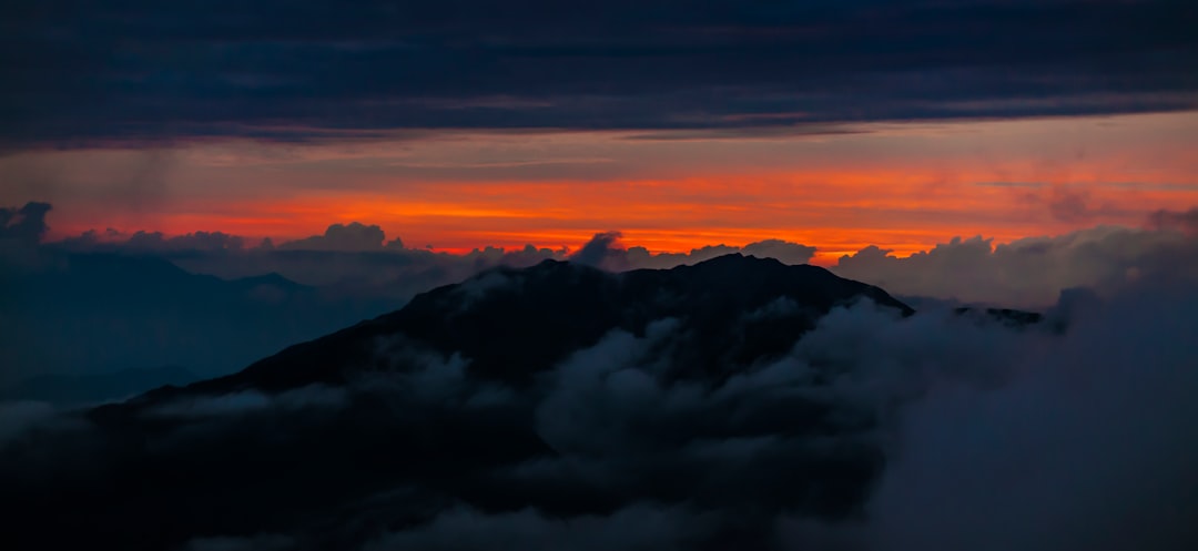 white clouds over mountains during daytime