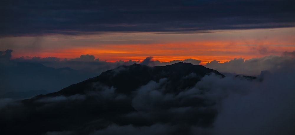 white clouds over mountains during daytime