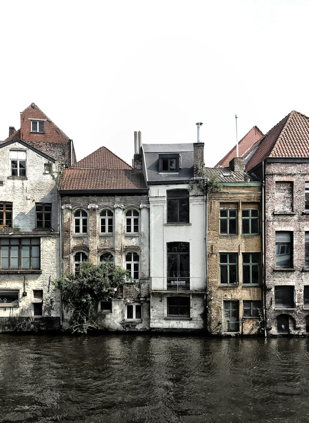 brown and white concrete building beside river during daytime