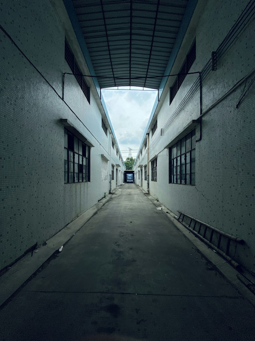 gray concrete hallway with blue and white walls