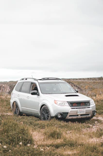 Silver SUV with roof rack, ready for weekend adventures on a country road