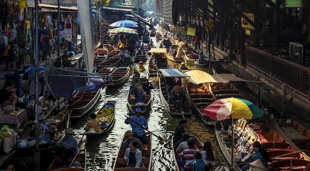 people riding on boat on river during daytime