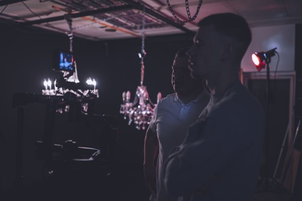 man in white dress shirt standing near people