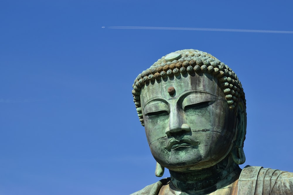 gray concrete statue under blue sky during daytime