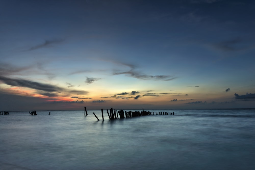 sea waves crashing on shore during sunset