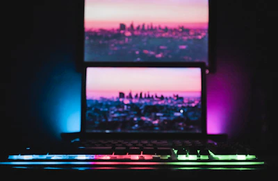 A freelancer working late with purple-blue ambient lighting and futuristic UI elements floating around.