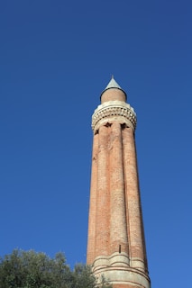 brown concrete tower under blue sky during daytime