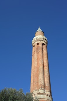 brown concrete tower under blue sky during daytime