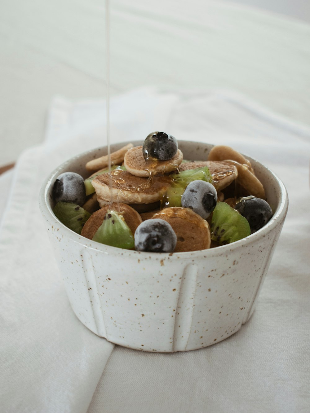 sliced fruits in white ceramic bowl