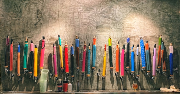 Stacks of colorful PTMT taps displayed to showcase variety and quality.