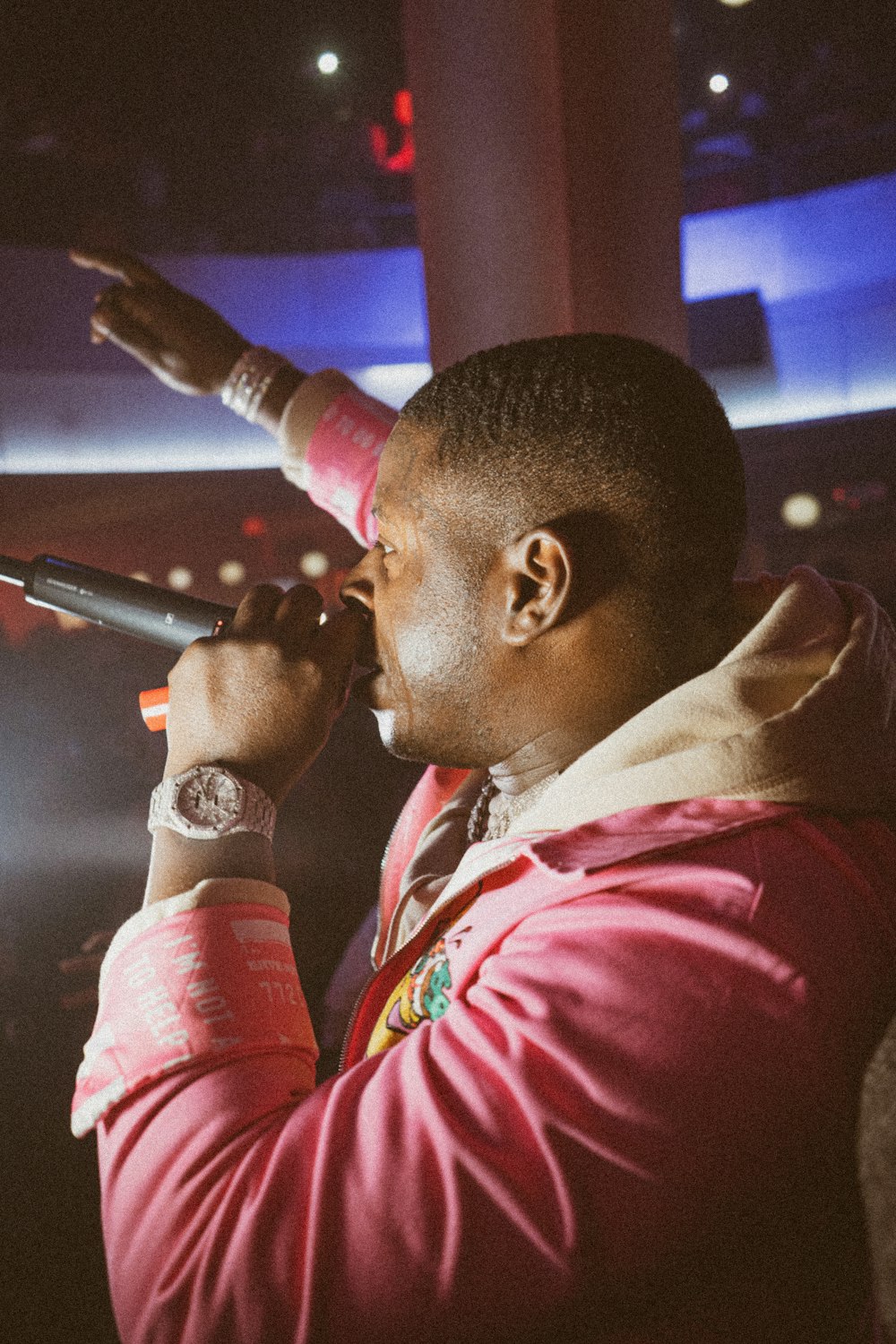 man in red shirt holding microphone