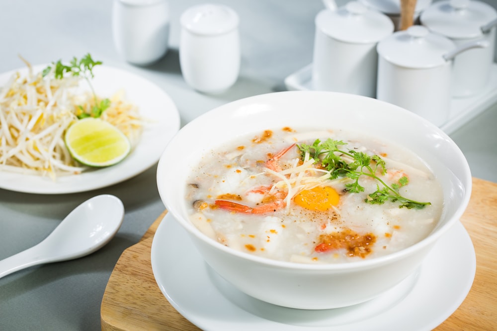 soup with sliced lemon on white ceramic bowl