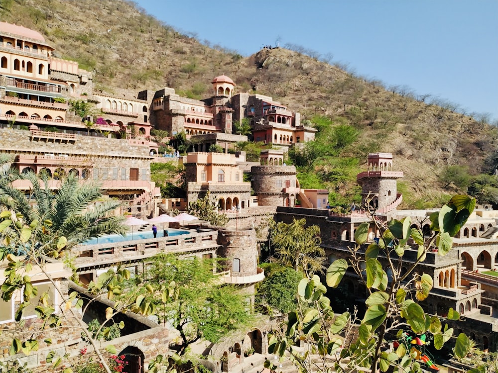 brown concrete building on mountain