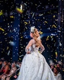 woman in white dress standing on stage