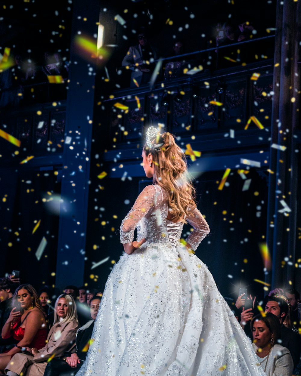 woman in white dress standing on stage