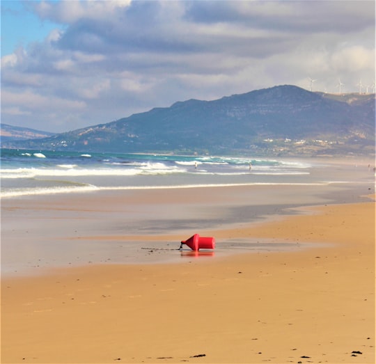 red and white tent on beach during daytime in Tarifa Spain