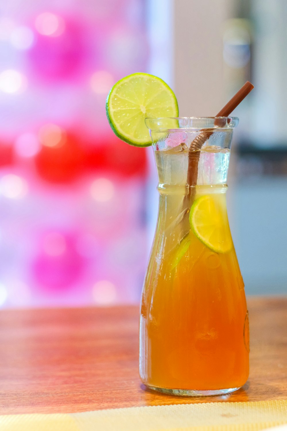 clear glass bottle with yellow liquid and sliced lemon