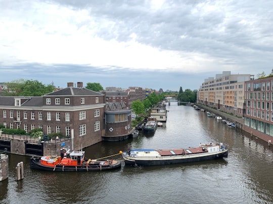 boat on river near buildings during daytime in Jodenbuurt Netherlands