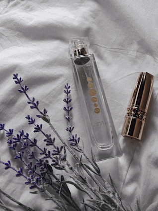 Elegant perfume bottles with golden accents resting on a vintage vanity with soft natural light